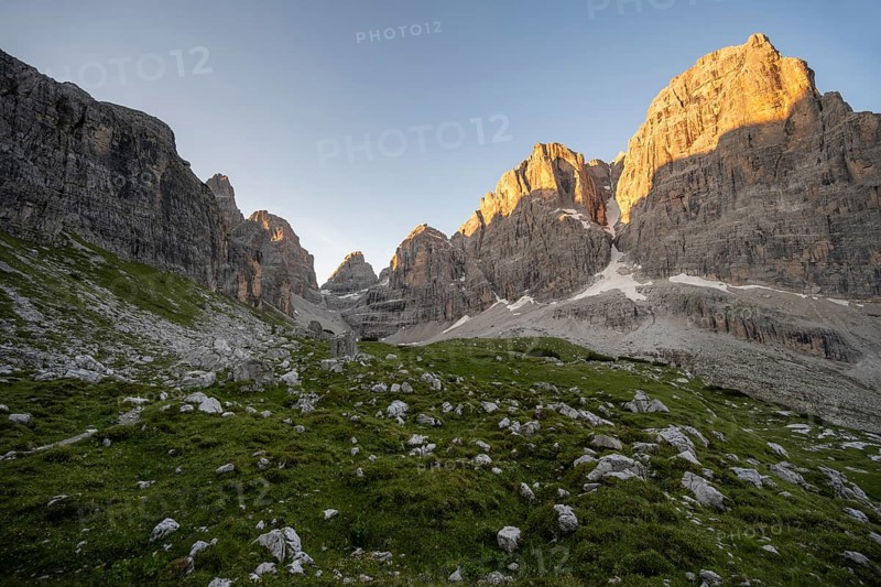 Picturesque mountain landscape in Val Brenta Alta at sunrise, rocky peaks of Cima Tosa, Alpenglühen, Brenta, Trentino, Italy