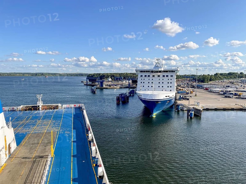 Large ferry is located in the port of Travemünde on, Scandinavia quay in the foreground dcas ceiling of an incoming TT line ferry surrounded by water and sunny skiesLübeck, Schleswig-Holstein, Germany
