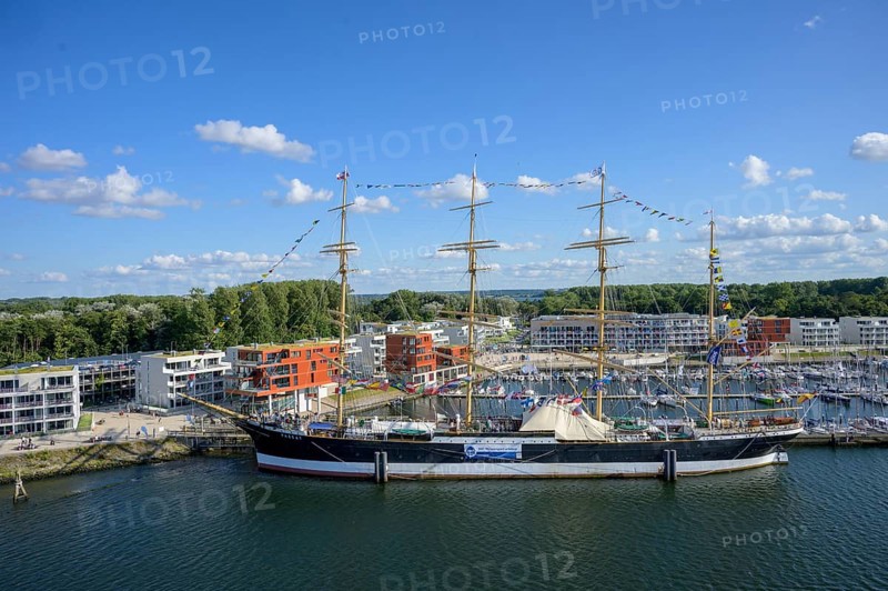 Harbour view with the legendary four-masted PASSAT barque and many boats in front of modern buildings under blue skies, Travemünde, Lübeck, Schleswig-Holstein, Germany