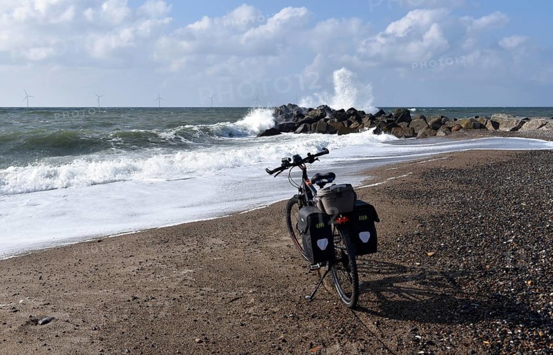 Bicycle and breakwater on the North Sea beach in Denmark