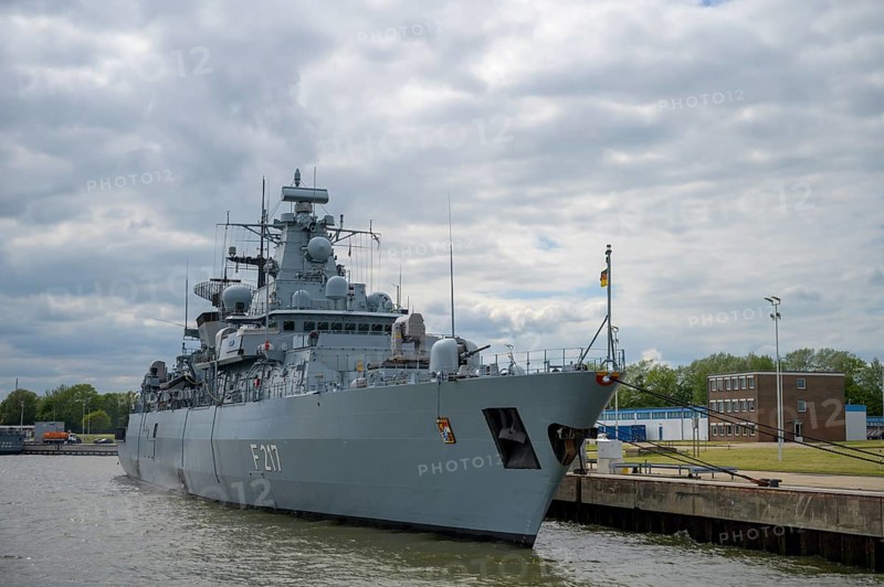 The frigate F217 Bayern, put into service on June 15, 1996 specializing in submarine hunting, is moored in the naval port of Wilhelshafen, the sky is cloudy, the atmosphere appears calm, Wilhelmshafen, Jade Bay, Lower Saxony, Germany