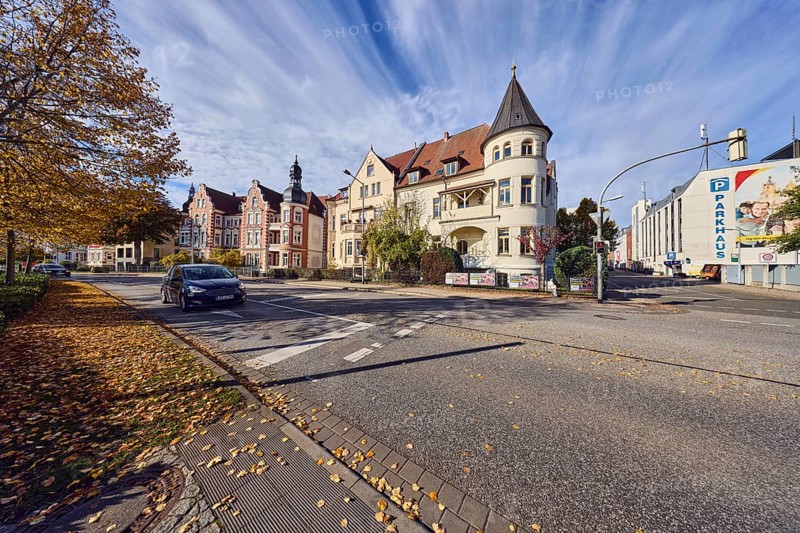 Historic residential buildings, turrets, balcony, façade with windows, Contipark parking garage Am Schloss, traffic light crossing, trees with autumn leaves, fallen leaves, blue sky, cumulus clouds, intersection Graf-Schack-Allee with Geschwister-Scholl-Straße, Schwerin, state capital, district-free city, Mecklenburg-Western Pomerania, Germany