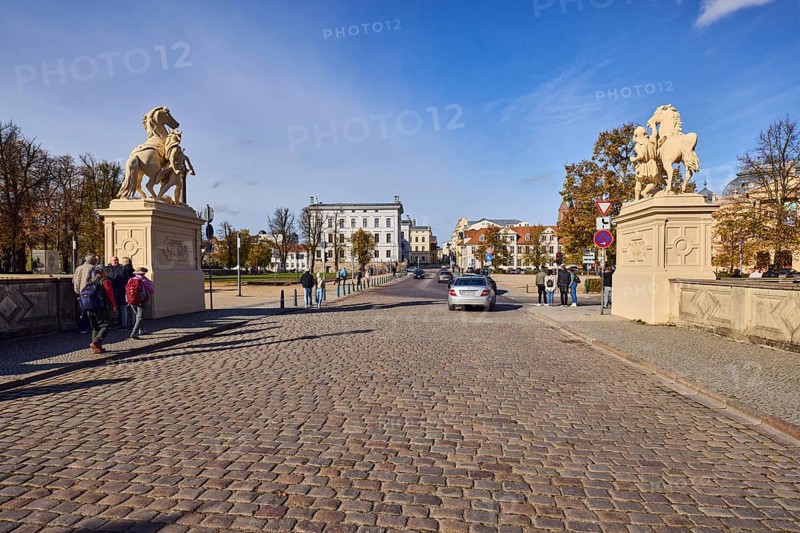 Entrance portal, horse sculpture, car bridge and footbridge, cobblestones, barrier bollard, sidewalk, historic building, general architecture, car, pedestrian as accessories, blue sky, cumulus clouds, cirrostratus clouds, castle bridge, intersection of Lennéstraße, Werderstraße and Schlossstraße, Schwerin, state capital, district-free city, Mecklenburg-Western Pomerania, Germany