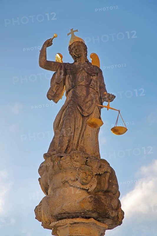 Justice as an angel and golden crown with cross and beam scale, golden wings, symbol of justice and law, stone sculpture, cutout, courtyard, Benedictine monastery, Neresheim, Härtsfeld, Swabian Jura, Baden-Württemberg, Germany