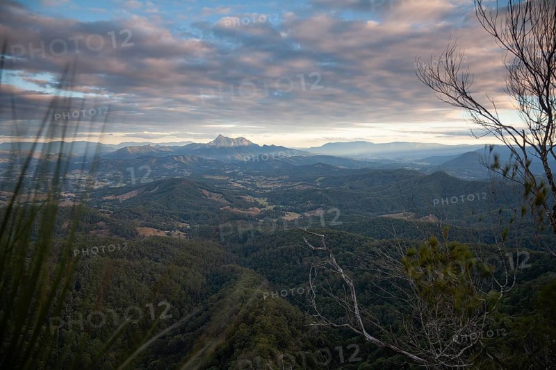 Sunset with an open view across the valley toward Mount Warning (Wollumbin), captured from the summit of Mount Cougal, highlighting natural depth and wide landscape perspective, Queensland and New South Wales, Australia