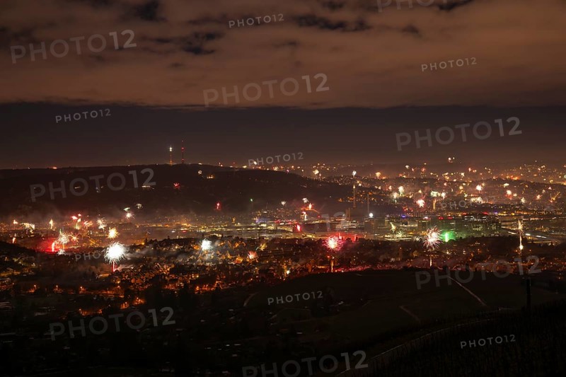 View from Kapellberg near Fellbach across the Neckar Valley to Stuttgart on New Year's Eve from 2025 to 2026. The television tower on the horizon as firecrackers and rockets light up the night sky at the turn of the year and greet the new year