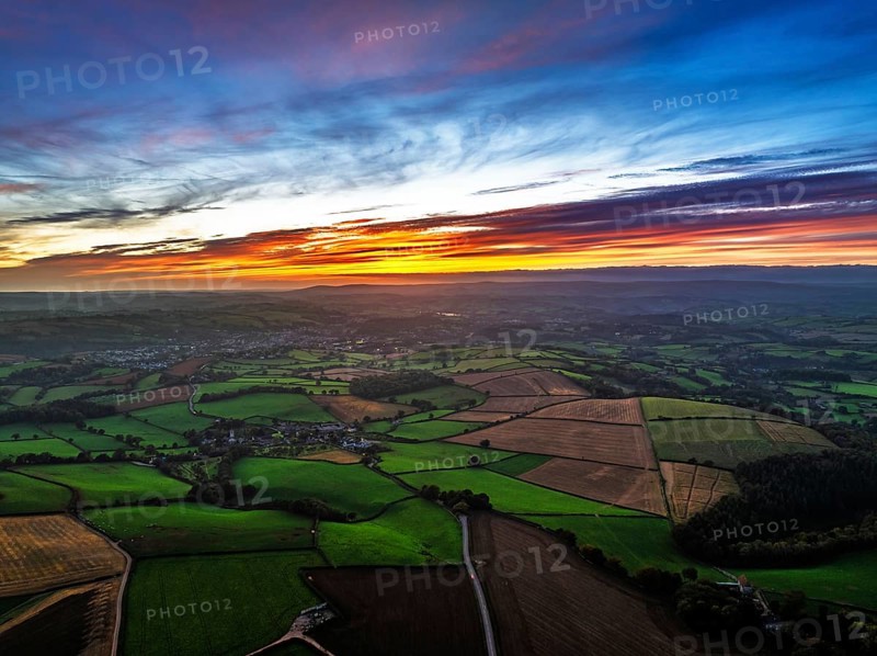 Sunset of Devon Farms and Fields over Berry Pomeroy from a drone, Totnes, England, United Kingdom