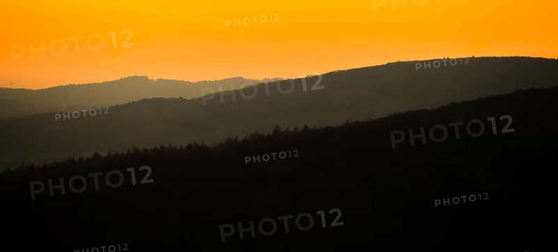 Silhouettes of mountains at sunset with orange sky, Vadsö, Finnmark, Norway