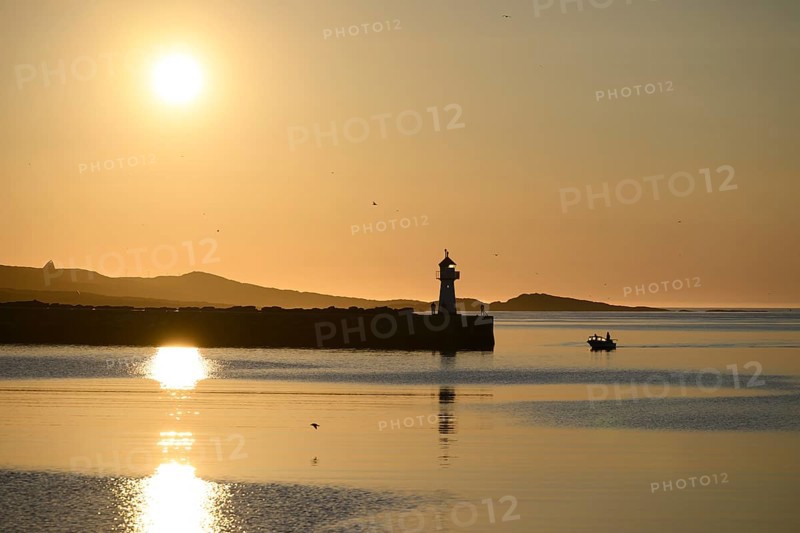Harbour entrance with lighthouse and midnight sun, Vardø, Finnmark, Norway