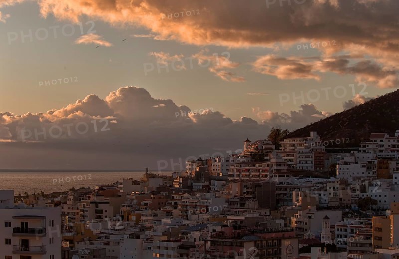 Urban panorama at sunset with clouds and coastal views, Los Cristianos, Tenerife