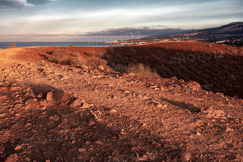 Sunrise over a barren hilly landscape with wide shadows, Los Cristianos, Tenerife