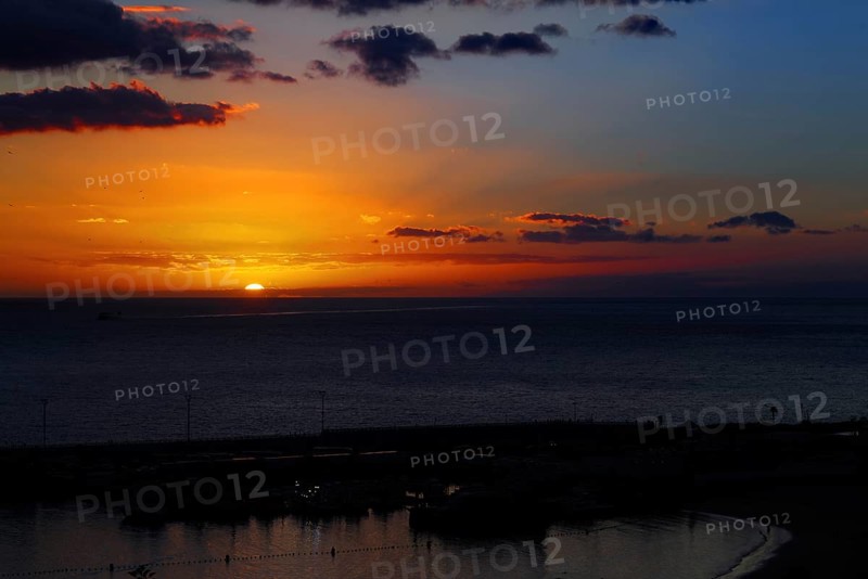 Dramatic sunset over the ocean with intense colors in the sky, Los Cristianos, Tenerife