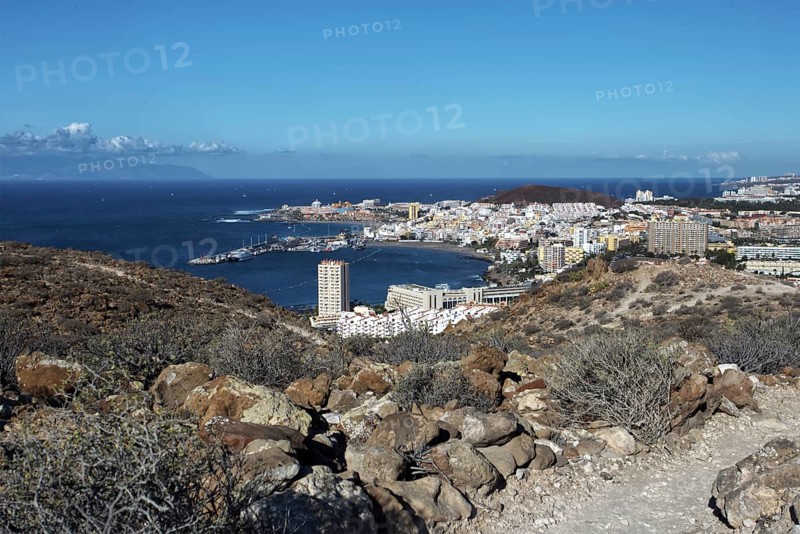 Hill view of the tourist town of Los Cristianos and the blue sea on a sunny day, Los Cristianos Tenerife