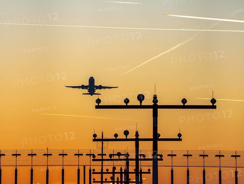Runway lighting, approach aids, at Düsseldorf International Airport, sunset, aircraft taking off, Hauptbahn Süd, 05R/23L, contrails from aircraft at higher altitudes, North Rhine-Westphalia, Germany