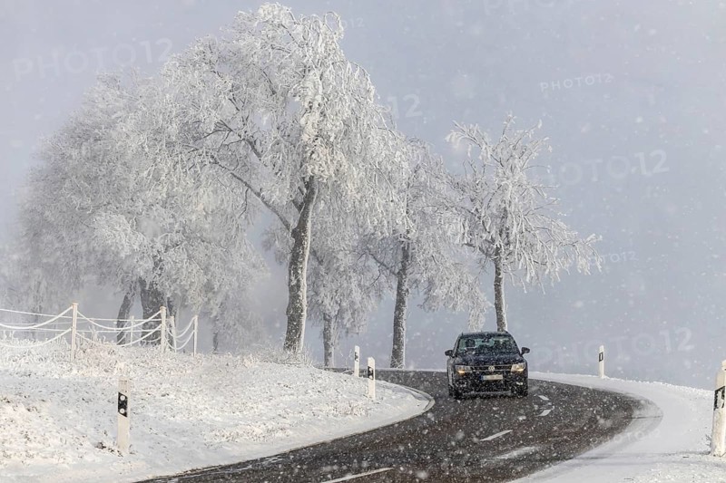 Winter in the Swabian Jura. Country road with snowy landscape near Westerheim, Alb-Donau-Kreis, Baden-Württemberg, Germany