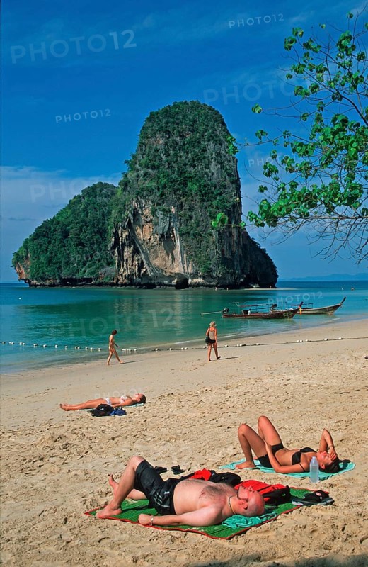 Rocks in the sea, people and longtail boats on Pranang Cave beach, two years in front of the tsunami, Krabi, Thailand, December 2002, vintage, retro, old, historic