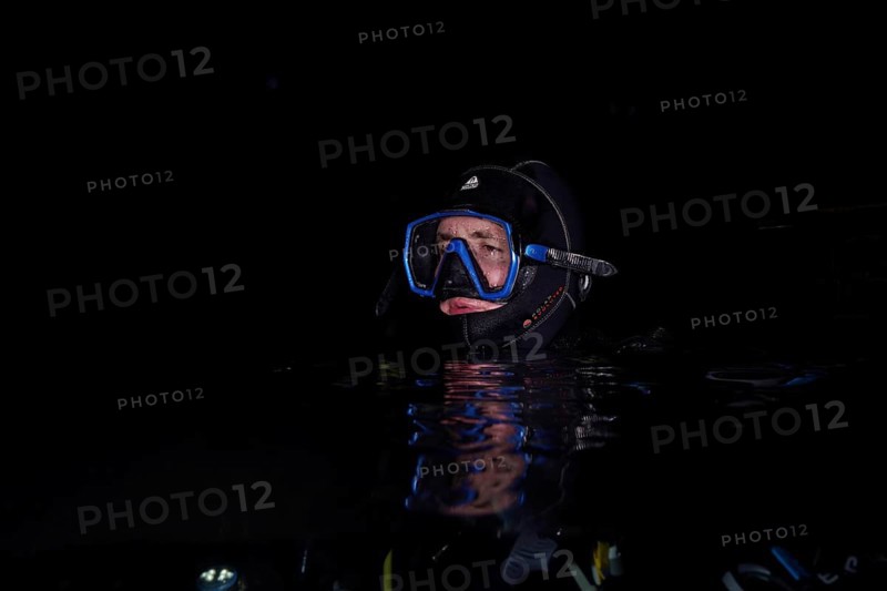 Divers at night in Lake Walen. Tauchplatz Känzeli, Mols, Canton of St. Gallen, Switzerland