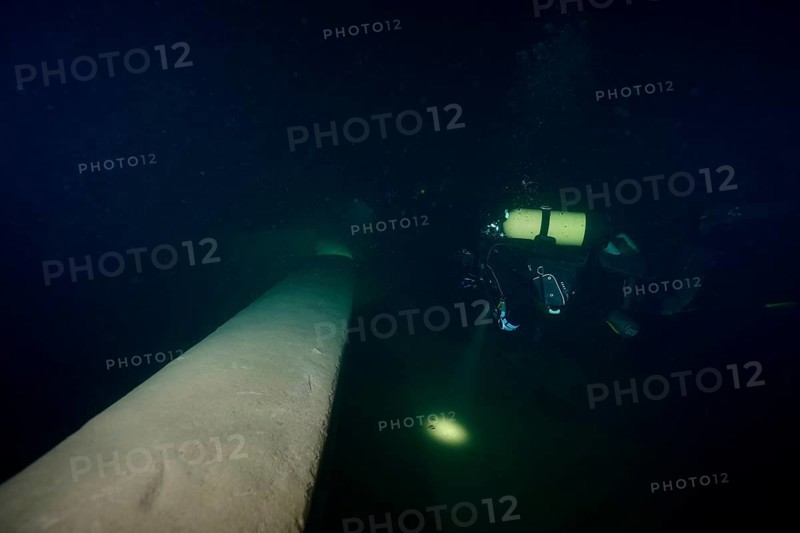 Diver examines a lediwreck, wreck of a lediship, ledi ship, cargo ship for mass freight, bulk cargo, at night in Lake Walen. Tauchplatz Känzeli, Mols, Canton of St. Gallen, Switzerland