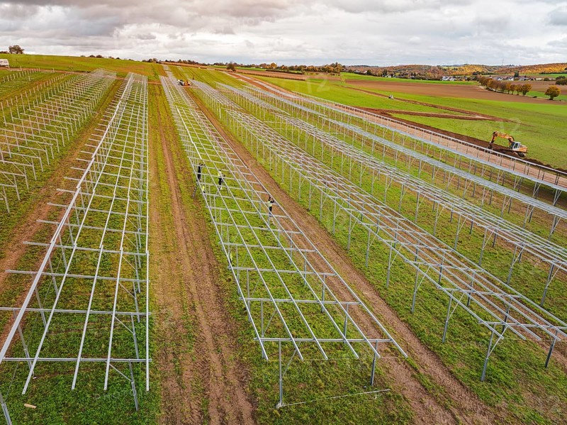 Technical structures of a solar plant under construction on wide fields, energy revolution, construction of PV open space, Baden-Württemberg, Germany