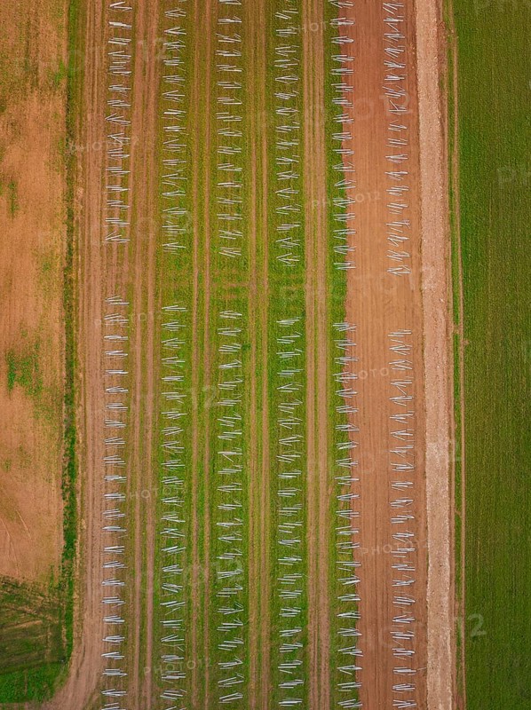 Aerial view of an agricultural field with evenly distributed solar racks in rows, energy transition, construction of PV open space, Baden-Württemberg, Germany
