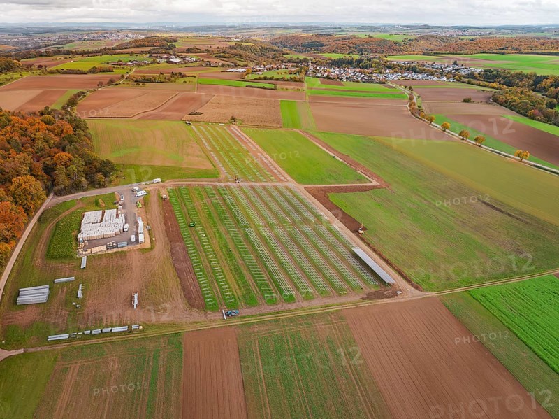 Panoramic view of fields with a solar park and an adjacent small village, Energiewende, construction of PV open space, Baden-Württemberg, Germany
