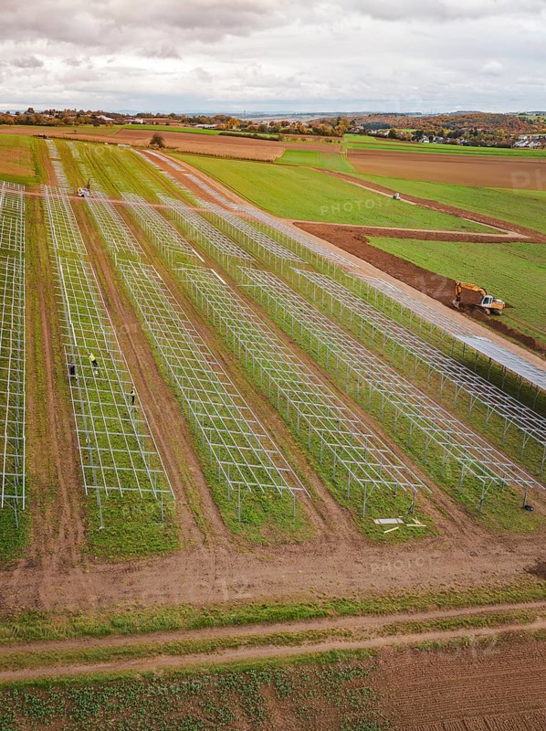 Start of a solar plant in fields with technical structures and a green environment, energy revolution, construction of PV open space, Baden-Württemberg, Germany