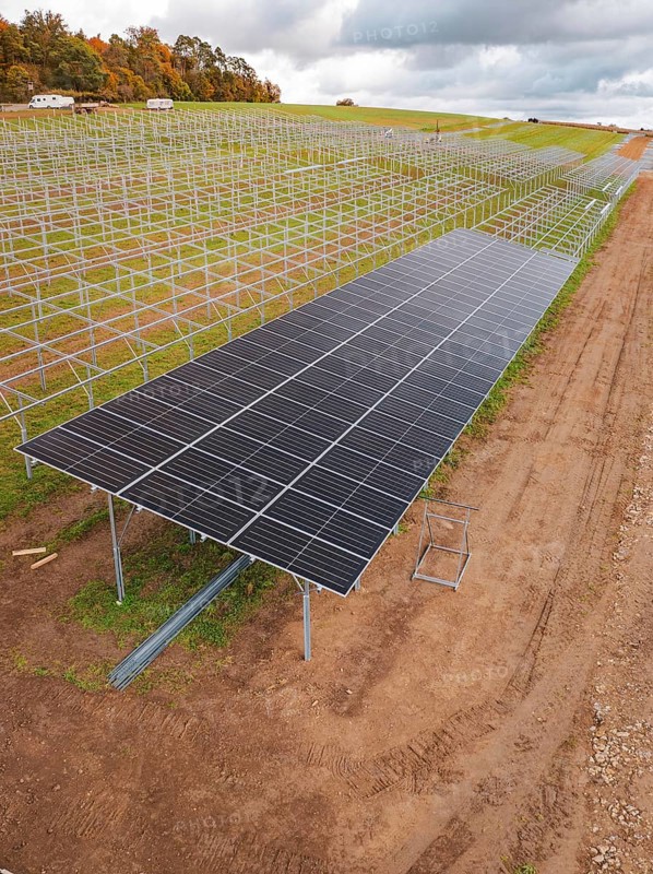 Solar system construction on a wide, cloudy field landscape, energy revolution, construction of PV open space, Baden-Württemberg, Germany
