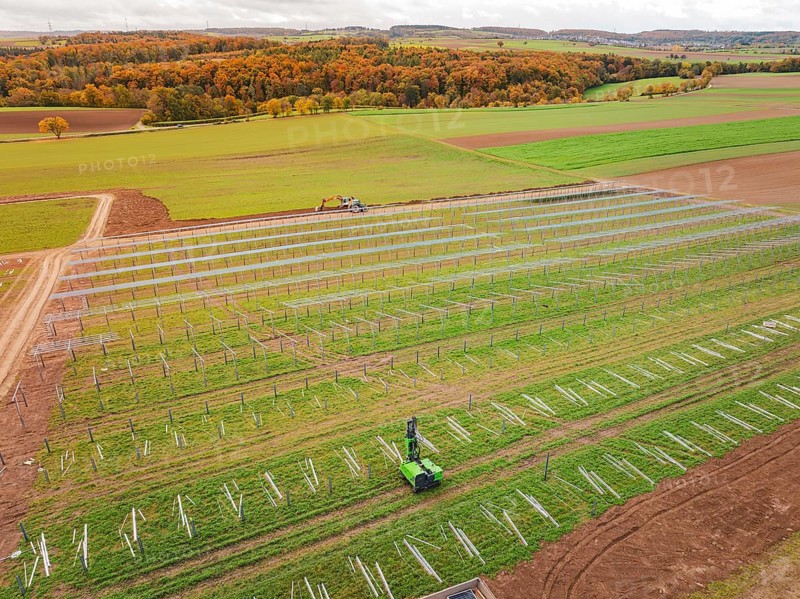Wide fields with solar panels and green landscape in the background, energy revolution, construction of PV open space, Baden-Württemberg, Germany