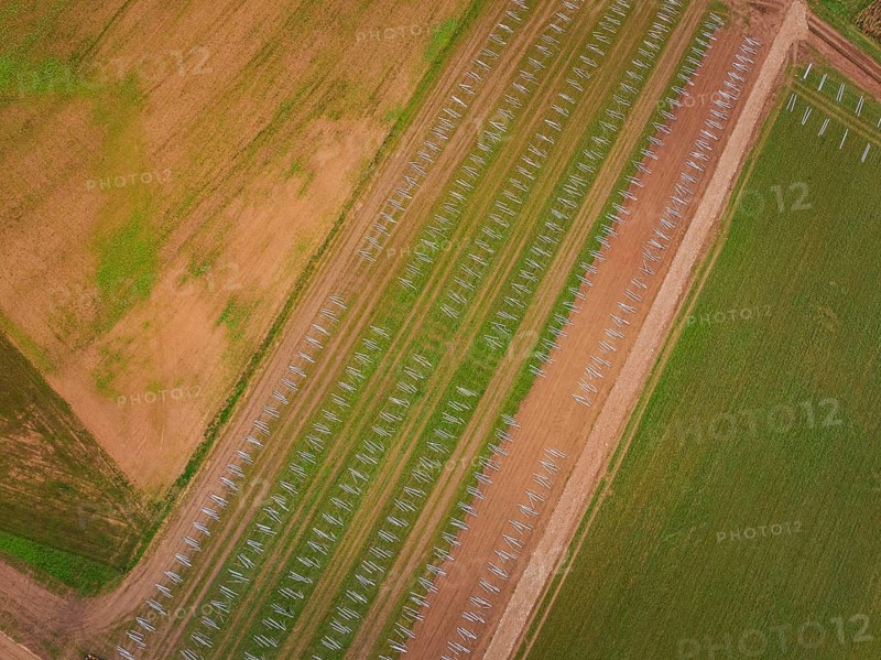 Aerial view of fields with staggered solar frame placement, surrounded by brown and green areas, energy transition, construction of PV open space, Baden-Württemberg, Germany
