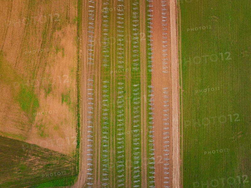 Aerial view showing fields in regular patterns with solar racks and arable land, energy transition, construction of PV open space, Baden-Württemberg, Germany