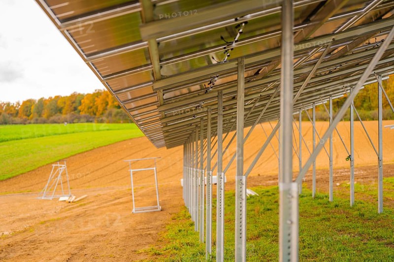 Metal structure for solar panels in a field next to an autumn forest, energy revolution, construction of PV open space, Baden-Württemberg, Germany