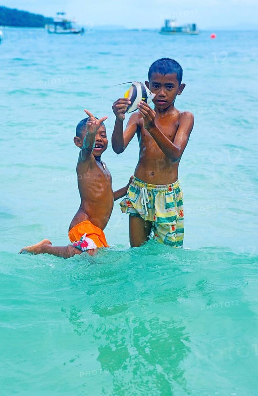 Two boys with a tropical fish on Ko Phi Phi Don, two years in front of the tsunami, Thailand, December 2002, vintage, retro, old, historic