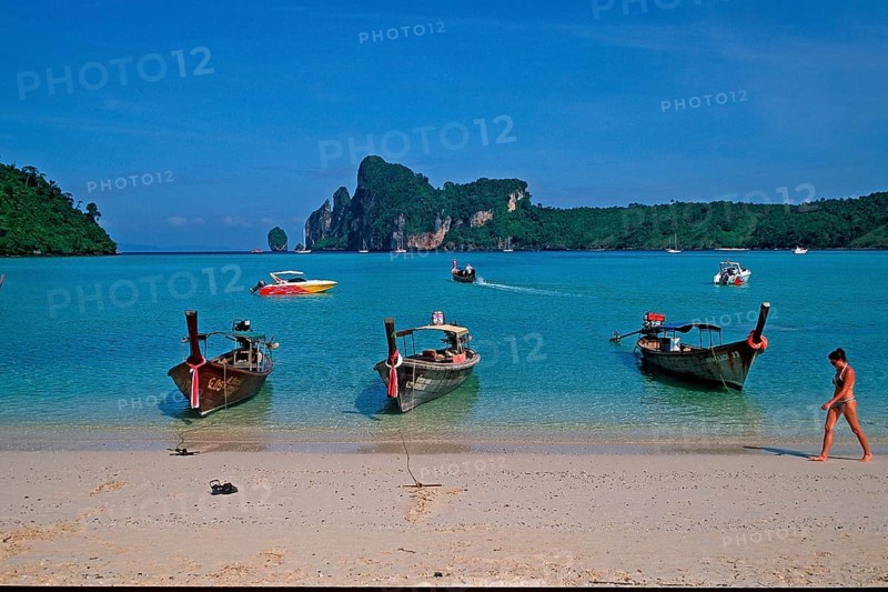 Young woman, longtail boats on the beach of Ko Phi Phi Don, two years in front of the tsunami, Thailand, December 2002, vintage, retro, old, historic