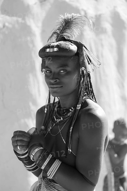 Black and white, portrait, brightly decorated woman of the Hakaona tribe, also Havakona or Hakawona, near Opuwo, Kunene, Namibia