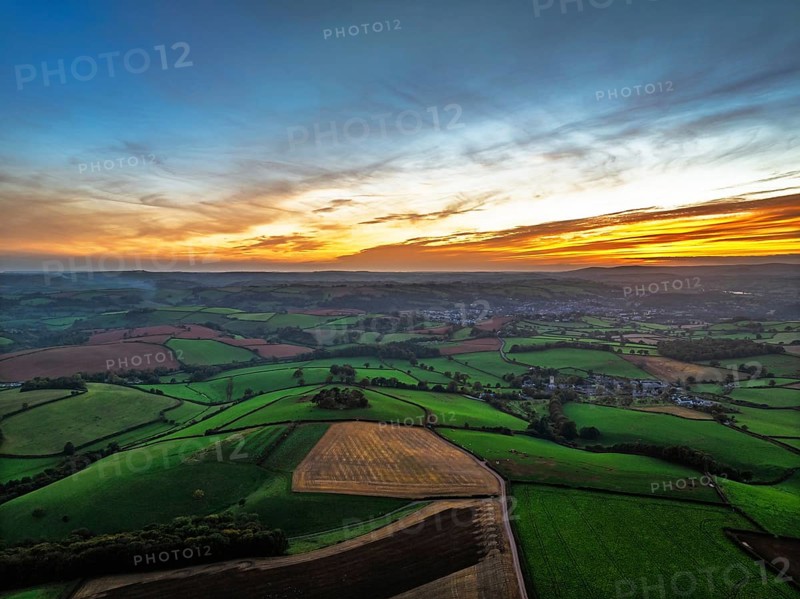 Sunset of Devon Farms and Fields over Berry Pomeroy from a drone, Totnes, England, United Kingdom