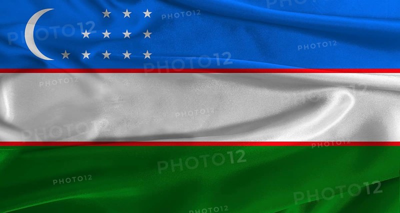 Flag of Uzbekistan with fabric textured background. Close up of National flag of Uzbekistan with realistic texture