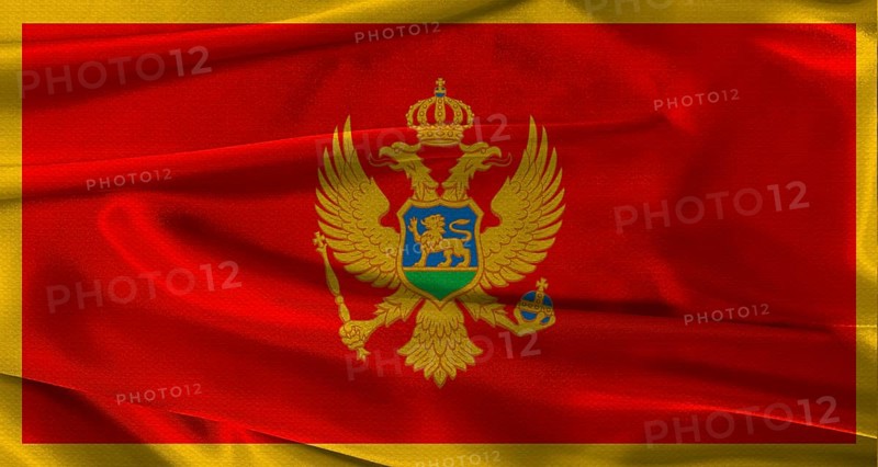 Flag of Montenegro with fabric textured background. Close up of National flag of Montenegro with realistic texture