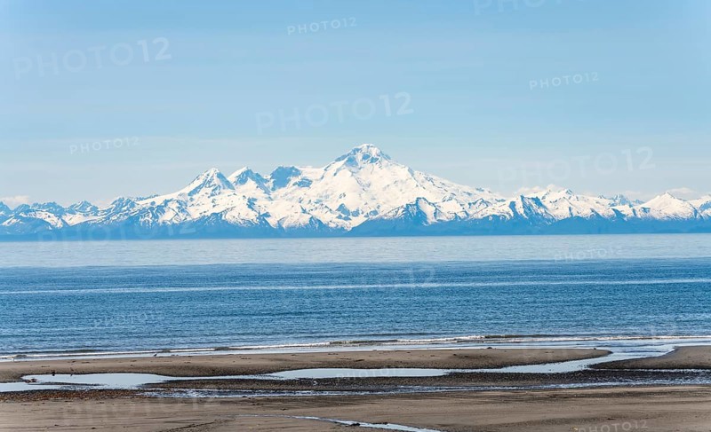 Beach at Anchor Point, Cook Inlet, glaciated mountain peaks of the Aleutian Range with Mount Iliamna summit, Anchor River State Recreation Area, Alaska, USA