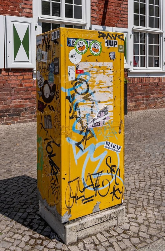Deutsche Post letterbox with stickers and graffiti, Potsdam, Brandenburg, Germany