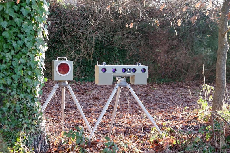 Radar meter, lightning system, traffic monitoring, speed control, speed shifter, A mobile radar system with photo camera is hidden between trees on the side of the road