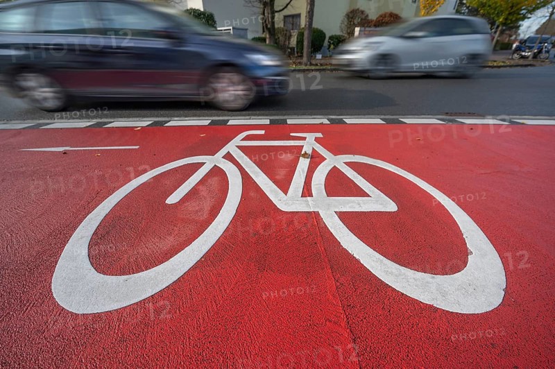 Car passing by the marked bicycle path, Röthebach, Mittelfranken, Bavaria, Germany