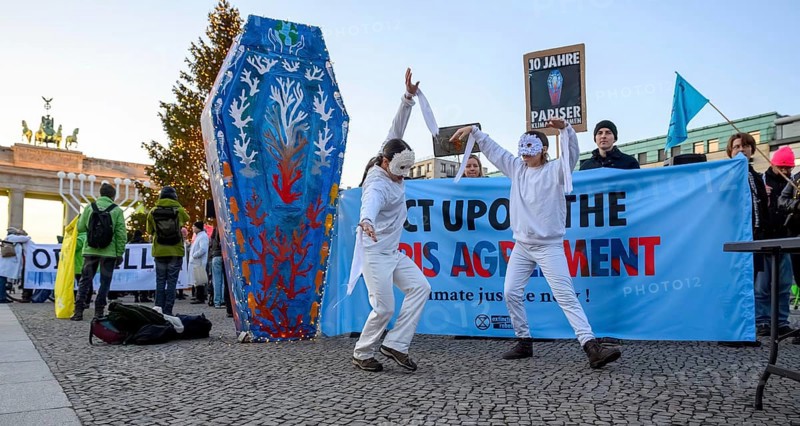 Dancers from Extinction Rebellion dance at Fridays for Future rally to mark the tenth anniversary of the Paris Agreement. Pariser Platz, Berlin, 12.12.2025