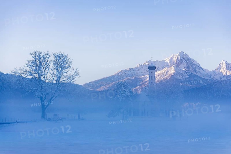 Snowy mountain landscape with St. Coloman pilgrimage church in the foreground and foggy background, Schwangau near Füssen, Ostallgäu, Allgäu, Bavaria, Germany