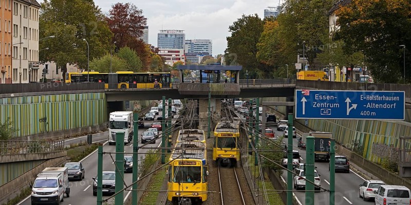 Lots of traffic on the A 40 motorway on four lanes and two subways on two lanes and a bus on the bridge, infrastructure, Essen, Ruhr area, North Rhine-Westphalia, Germany