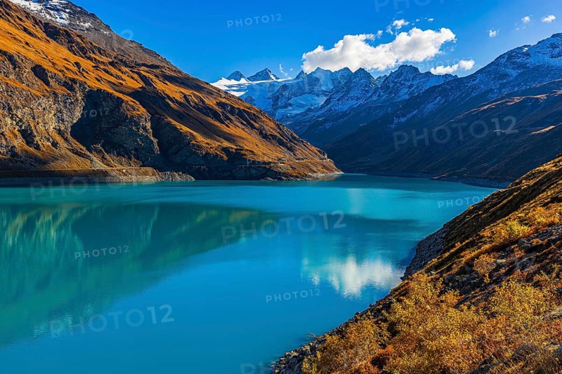 The Lac de Moiry reservoir, with the snow-capped peaks of the Grand Cornier, Tete Blanche and Pointe Moiry mountains, Val d'Anniviers, Valais Alps, Canton of Valais, Switzerland
