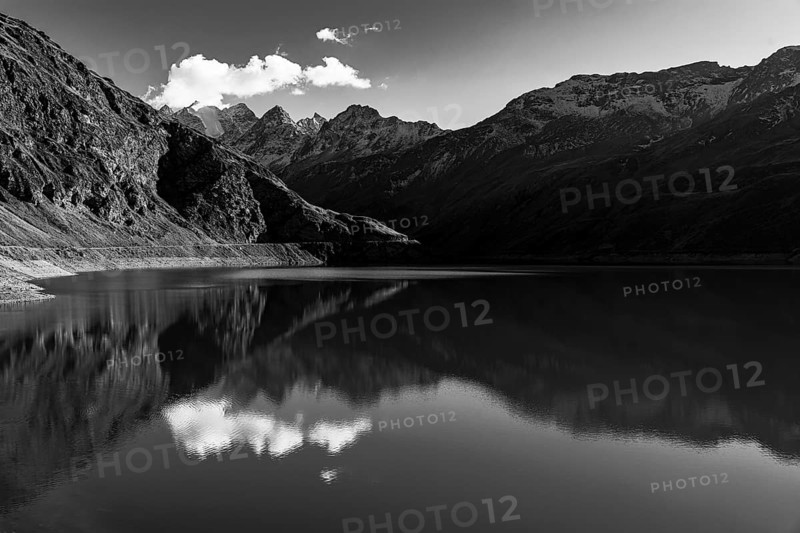 The Lac de Moiry reservoir, in the background the peaks of the Grand Cornier, Tete Blanche and Pointe Moiry mountains, black and white photo, Val d'Anniviers, Valais Alps, Canton of Valais, Switzerland