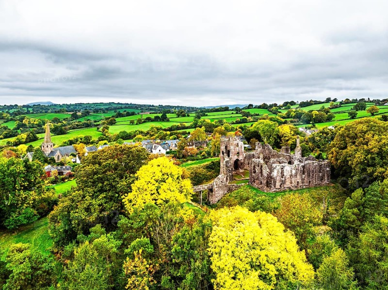 Autumn Colours over ruins of Grosmont Castle from a drone, Grosmont, Monmouthshire, Wales, UK