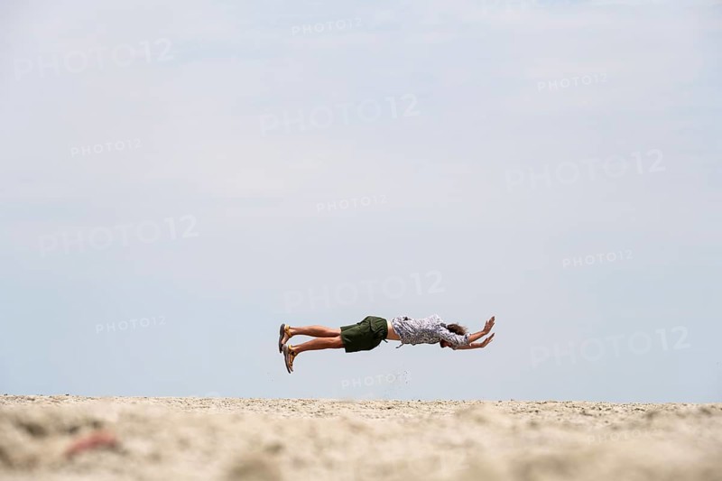 Abstract, man jumping horizontally at the Etosha pan, salt pan, Etosha National Park, Namibia