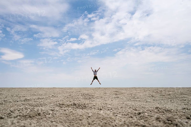Symbolic picture, abstract, man jumping on the Etosha pan, salt pan, Etosha National Park, Namibia