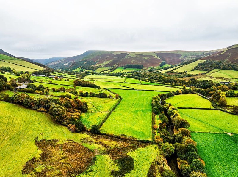 Autumn colours of Farms over River Wye and Road A470 from a drone, Llanidloes, Powys, Montgomeryshire, Wales, UK